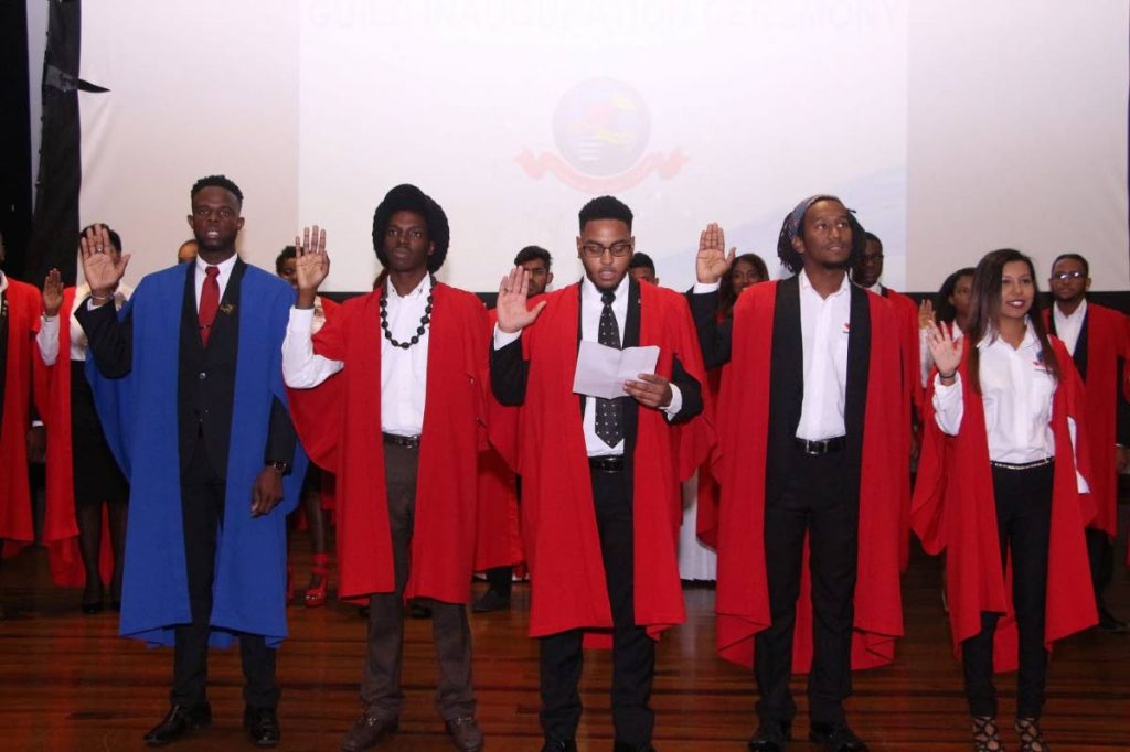 WE SWEAR: Guild president Justin Subero, centre,  at the swearing-in ceremony with  members of the executive, from left, Devon Harris, Nathanael John, Darweshi Gyton-Baptiste and Teshanna Mohammed. PHOTO COURTESY THE UWI