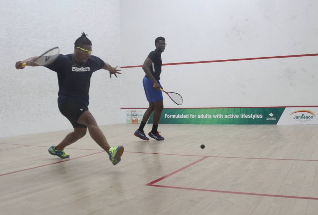 David Pitcairn, left, of Cayman Islands and Khamal Cumberbatch of Barbados at the 2019 Junior Caribbean Area Squash Association (CASA) Championships, yesterday. Cumberbatch won 11-3, 11-5, 11-2. PHOTO BY AYANNA KINSALE 