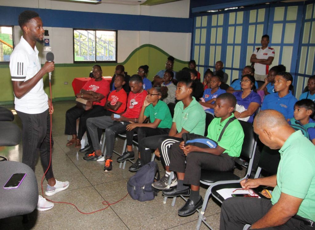 Children listen to the inspiring words of athlete Jereem Richards.
