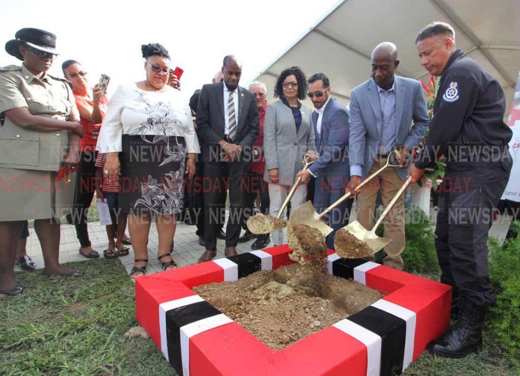 SHOVELLING DIRT: (from right) Commissioner of Police Gary Griffith, Prime Minister Dr Keith Rowley and Minister of National Security Stuart Young turn the sod to signal the start of construction of the new Carenage police station on Tuesday.  PHOTO BY ANGELO M MARCELLE
