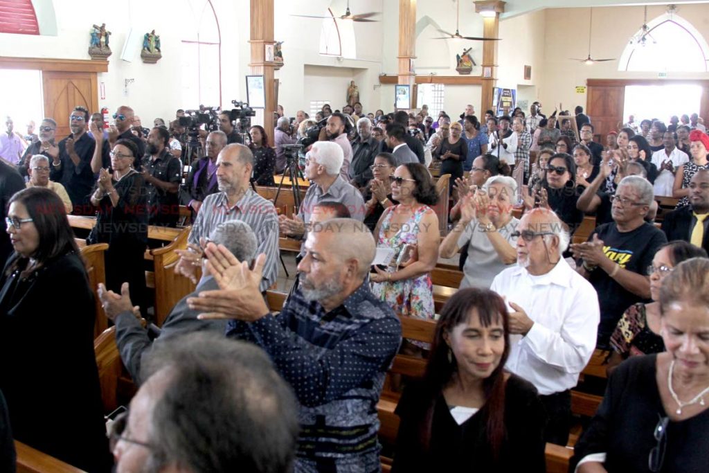Standing ovation for the master director and producer Raymond Choo Kong at his funeral at the Santa Rosa RC Church in Arima on Wednesday.  PHOTO BY ROGER JACOB
