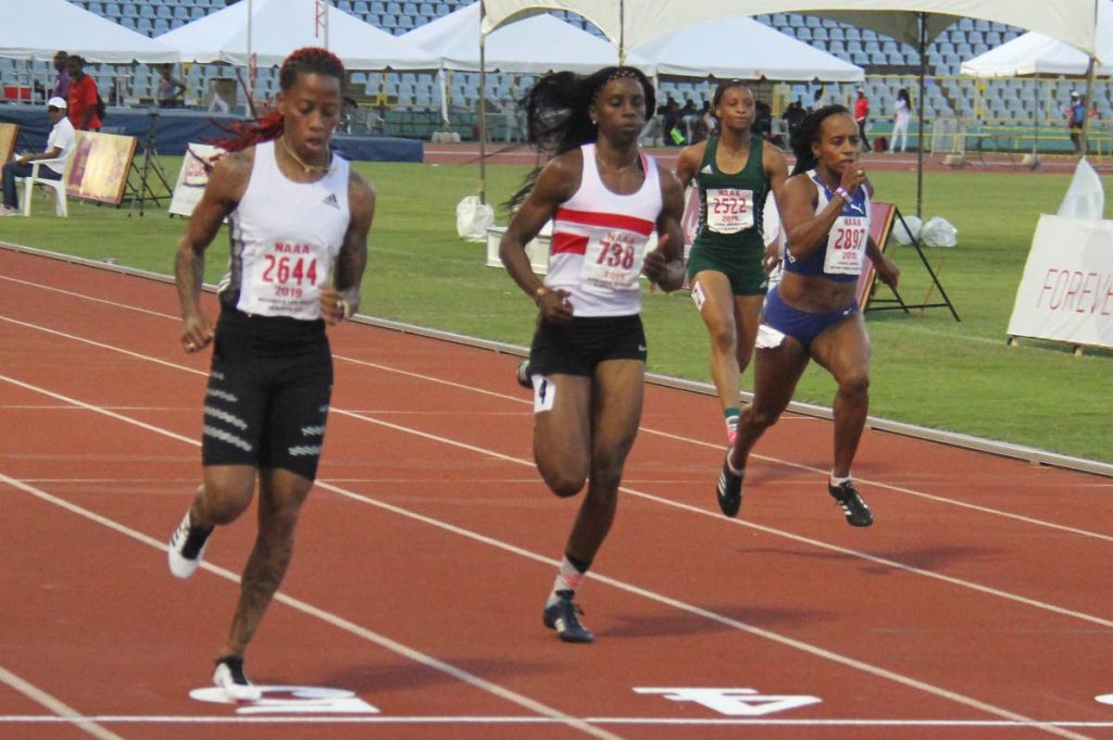 Michelle Lee Ahye of club Rebirth, left, finished first in the 100m prelims at the NGC/Natonal Association of Athletics Administrations Open Championships at the Hasely Crawford Stadium yesterday. Placing second was Kamaria Durant of Simplex and third, Tahesia Harrington-Scott of British Virgin. PHOTO BY AYANNA KINSALE 