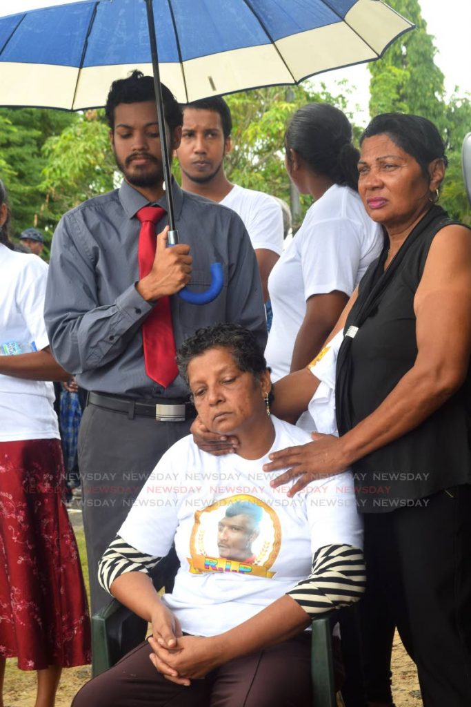 DAZED: Samoo Ali sits during the funeral for her son, murdereed fisherman Anand 