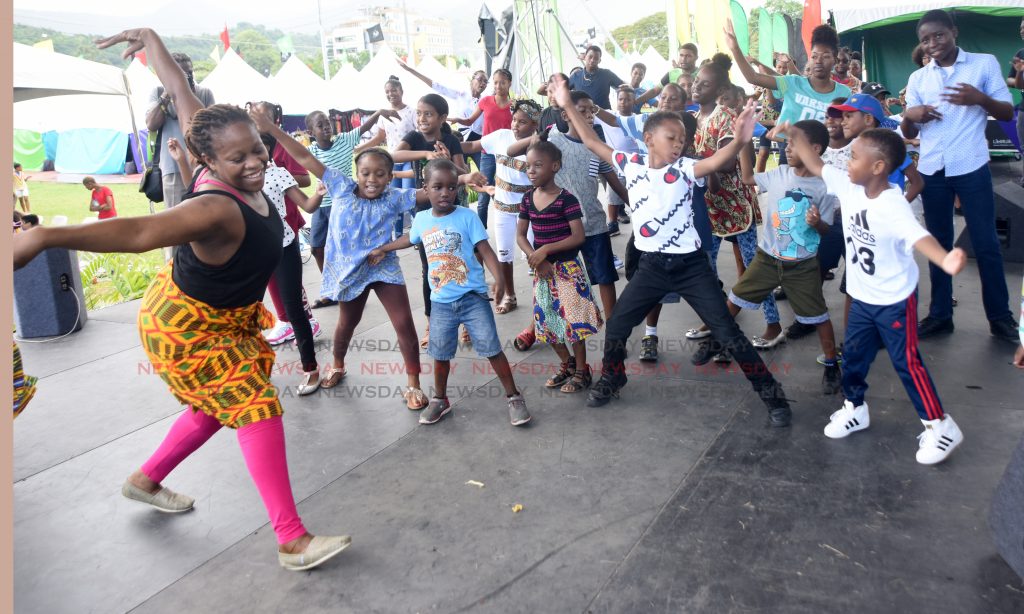 Magnita Clement from Wasafoli dance group teach children from Hummingbird Day Camp African dance during Pan African Festival TT youth day at Emancipation Village Queen Park Savannah, Port of Spain.

Photo: Kerwin Pierre