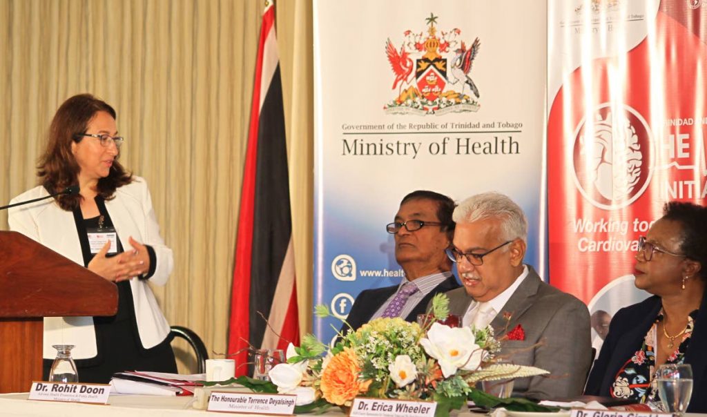 Dr Gloria Giraldo, specialist non-communicable diseases and mental health at PAHO/WHO speaks at the TT Global Hearts Initiative at the Hilton, Port of Spain. At the table are Dr Rohit Doon - advisor health promotion and public health, Minister of Health Terrence Deyalsingh and Dr Erica Wheeler, PAHO country representative TT.  PHOTO BY ROGER JACOB