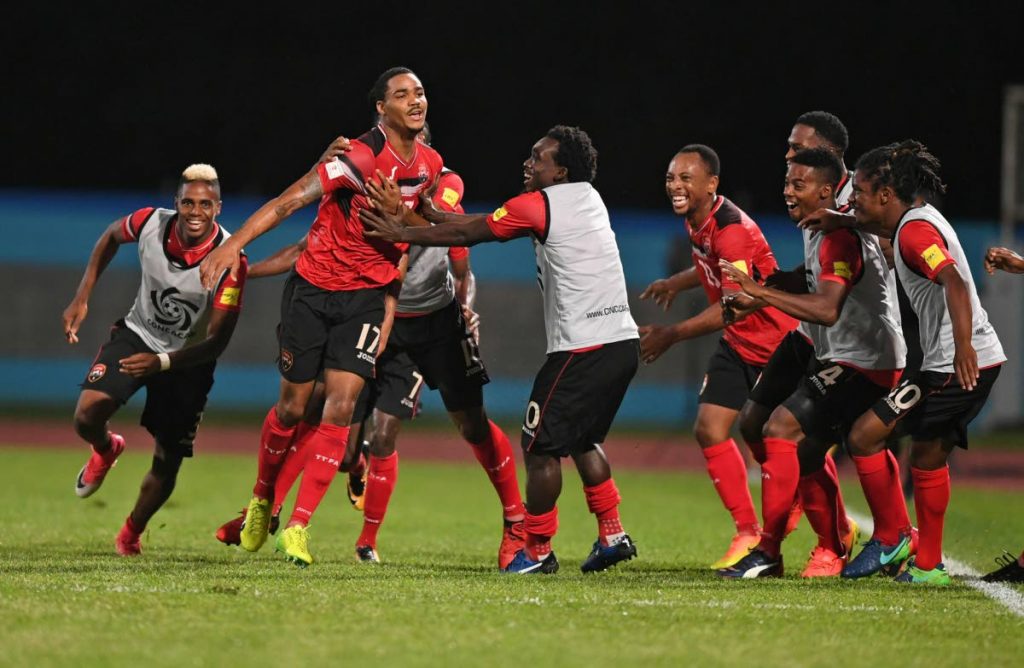National footballer Alvin Jones, second from left, celebrates after scoring against the USA in a 2018 World Cup qualifier at the Ato Boldon Stadium, Couva. TT beat USA 2-1 to eliminate their rivals from Russia. 