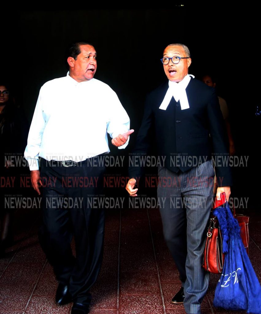 GUILTY: Stephen Gocking, left, and his attorney Larry Williams leave the Hall of Justice, Port of Spain.