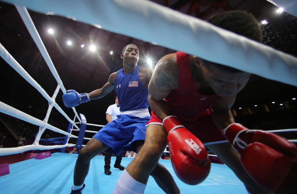 Keyshawn Davis of the US (left), throws a punch to Michael Alexzander of Trinidad and Tobago during the third round of their men’s welterweightg boxing semifinal match at the Pan American Games in Lima, Peru, on Tuesday. (AP PHOTO)