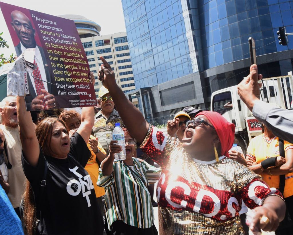 A supporter of Prime Minister Dr Keith Rowley faces off with pro-opposition and anti-government protesters outside the Parliament building in Port of Spain yesterday. 