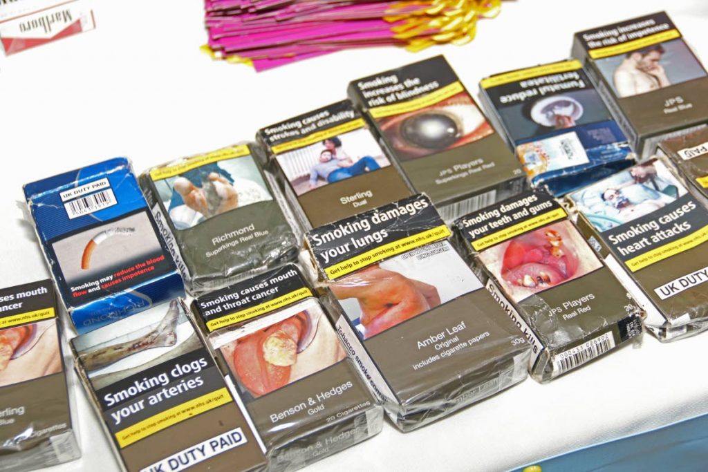 An example of warning labels on cigarette packaging in the UK on display at the SWRHA launch of the smoking cessation clinic at C3 Centre, San Fernando, on Wednesday. PHOTO BY: MARVIN HAMILTON