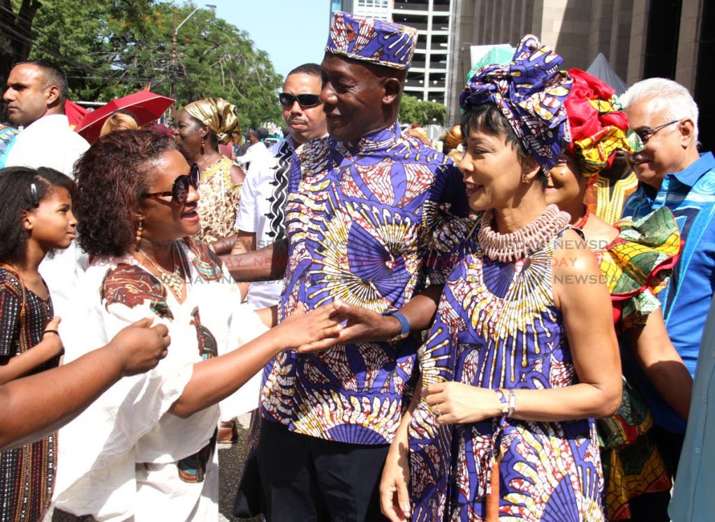 EMANCIPATION GREETINGS: Prime Minister Dr Keith Rowley and his wife Sharon greet the public at the Emancipation Day parade in Port of Spain, on Thursday.