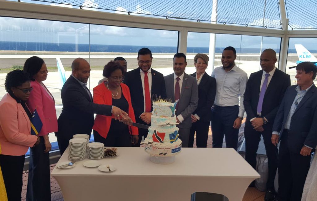 
Government and CAL representatives from both Curacao and TT look on as Curacao Transport Minister, Zita Jesus-Leito and Minister of Economic Development, Kenneth Gijsbertha cut a cake at a reception celebrating CAL's inaugural flight to Curacao at the Curacao International Airport on Friday. PHOTO BY JANELLE DE SOUZA