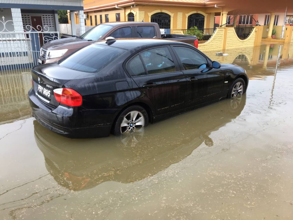 A car stalled in flood waters in Beaulieu Avenue, Trincity.