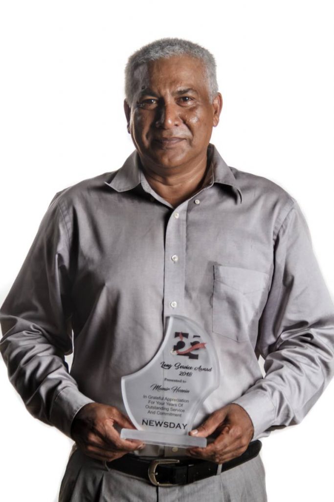 Newsday paginator Munir Hosein proudly holds his award for 20 years of service during the company's 25th anniversary celebrations in 2018. 