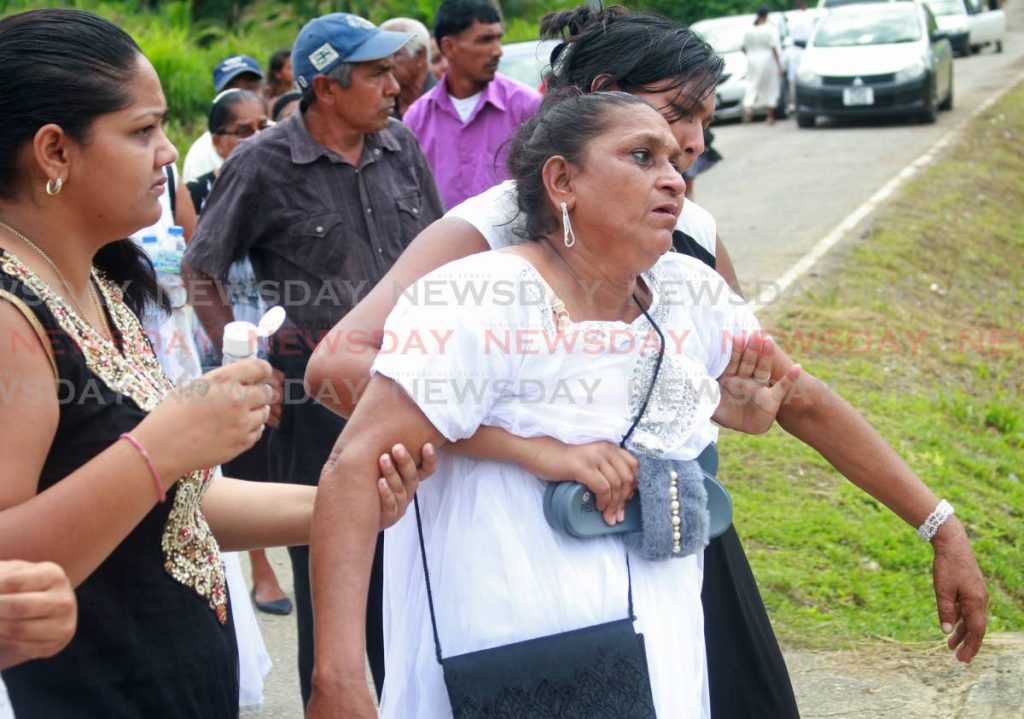 Mary Kuarsingh, wife of Harrilal Jagroop, breaks down at his funeral on Wednesday. PHOTO BY CHEQUANA WHEELER