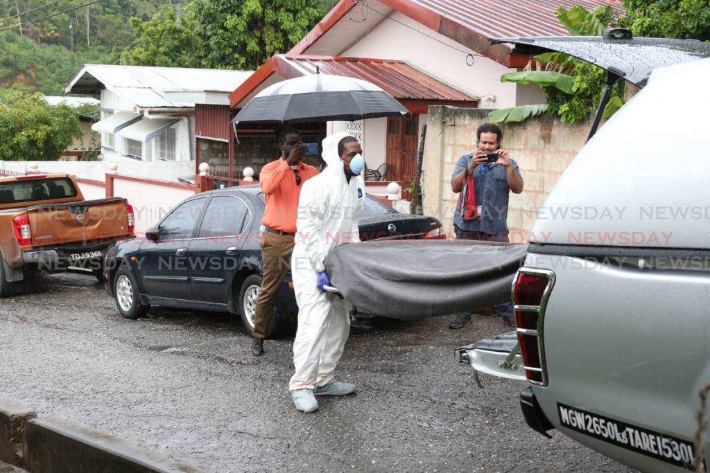 Undertakers from OP Funeral Directors Ltd remove the bodies of two men from a Rav4 at a murder scene at Pipiol Circular Road, Santa Cruz, on Wednesday. JEFF K MAYERS