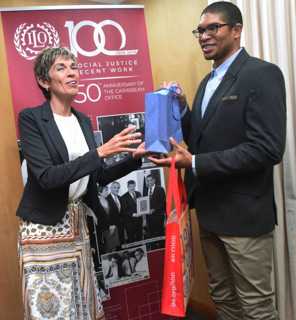 ILO Caribbean director Claudia Coenjaerts presents Matthue Prescott with the top prize of the ILO 