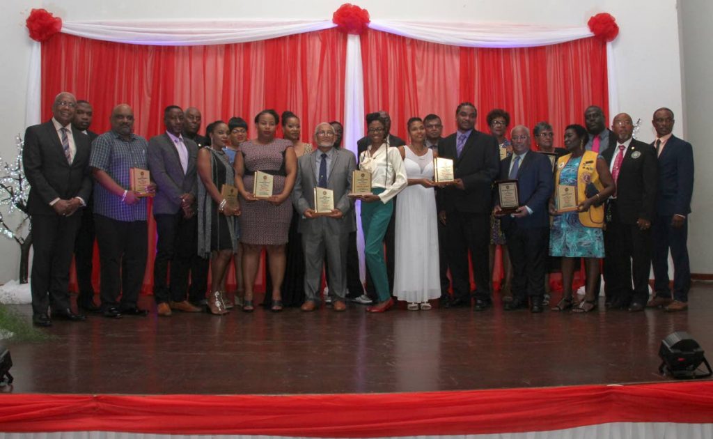 Minister of Education Anthony Garcia, left, with awardees at the Arima Borough Council Annual Award Ceremony at the Arima New Government School Auditorium last Wednesday. 