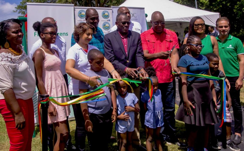 Housing Minister Edmund Dillon, centre, cuts the ribbon to a community park at Adventure Housing Development, Plymouth, Tobago alongside Chief Secretary Kelvin Charles, third from right, Tobago West MP Shamfa Cudjoe, First Citizens officials and residents on Saturday. PHOTO BY DAVID REID