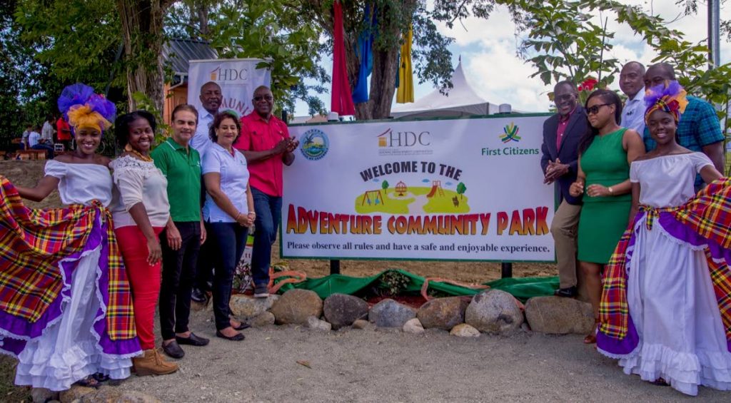 
Housing Minister Edmund Dillon, right, and Chief Secretary Kelvin Charles, left, with First Citizens and housing officials and performers at the opening of Adventure Community Park in Plymouth on Saturday. PHOTO BY DAVID REID