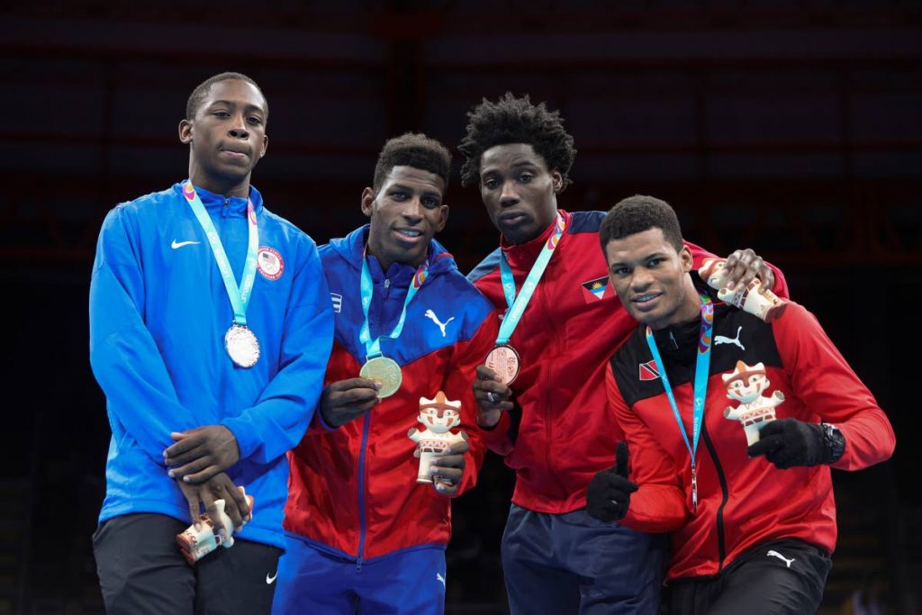 Silver medallist Keyshawn Davis of the United States, left, champion  Andy Cruz of Cuba, centre, and bronze medallists Alston Ryan of Antingua and Barbuda, second right, and Michael Alexander of TT in the men's light welterweight boxing at the Pan American Games in Lima, Peru, earlier this month.