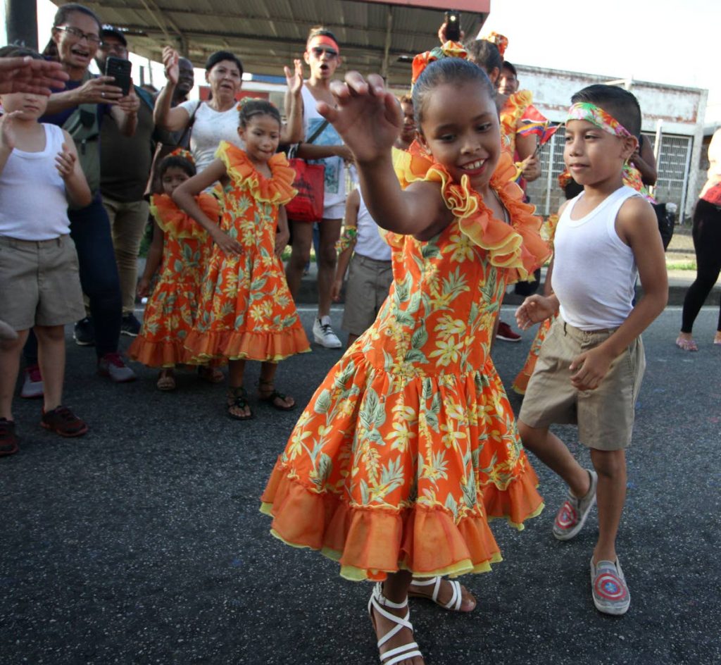 Two members of La Burriquitas dance during Arima Borough Day celebrations on Saturday. 