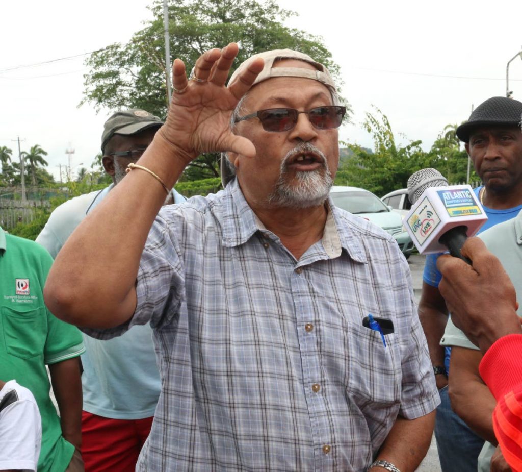 Former Petrotrin worker Dhanraj Goolcharan speaks to media as he and his former co-workers protest changes to their medical plan outside the closed refinery on Thursday. PHOTO BY MARVIN HAMILTON