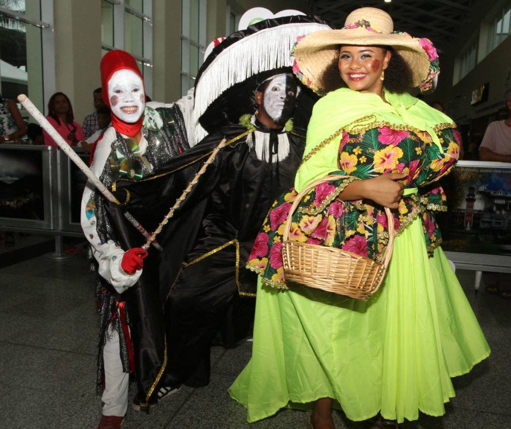 A Pierrott Grenade, Midnight Robber and Dame Lorraine, welcome Carifesta delegates at the Piarco International Airport on Thursday. PHOTO BY ANGELO MARCELLE