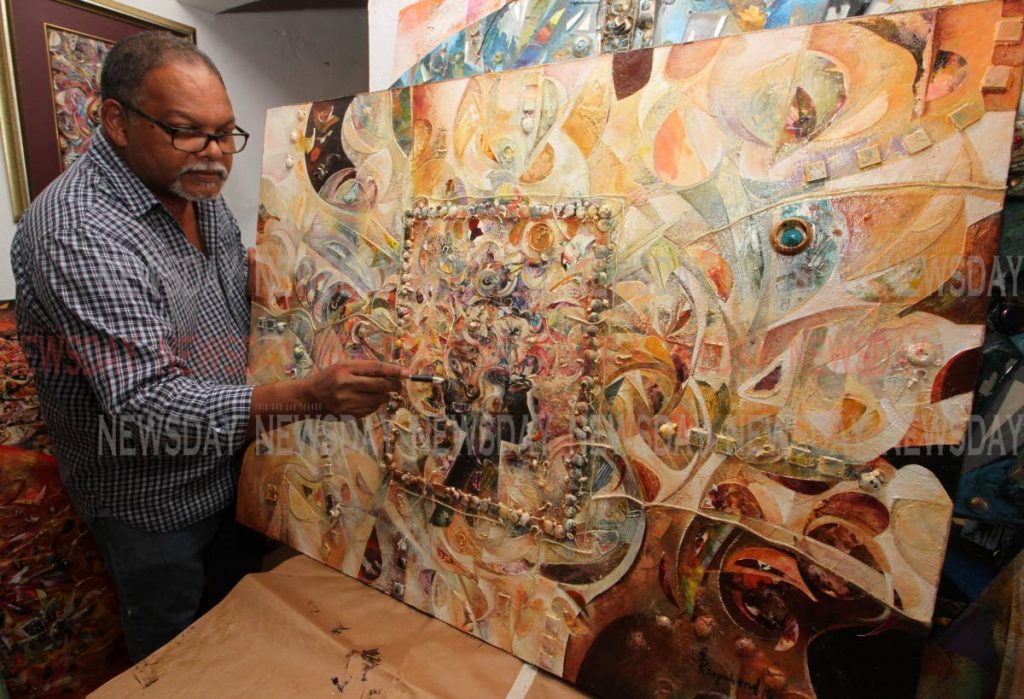 Artist Glenn Mohammed reviews his piece Vande Materam, one of his creations for his exhibition Parade. PHOTOS BY ANGELO MARCELLE 
