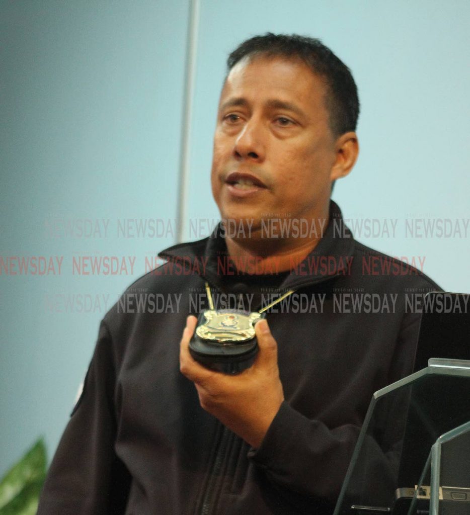 Commissioner of Police Gary Griffith shows the new police identification badge as he addresses the media at the Police Administration Building, Port of Spain, yesterday. PHOTO BY ANGELO MARCELLE
