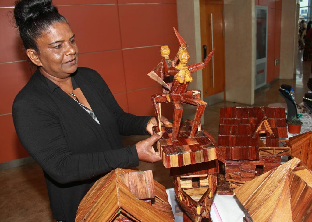 Radica Vialva displays a piece created by her son at a Carifesta showcase, Southern Academy for the Performing Arts, San Fernando on August 18. PHOTO BY CHEQUANA WHEELER