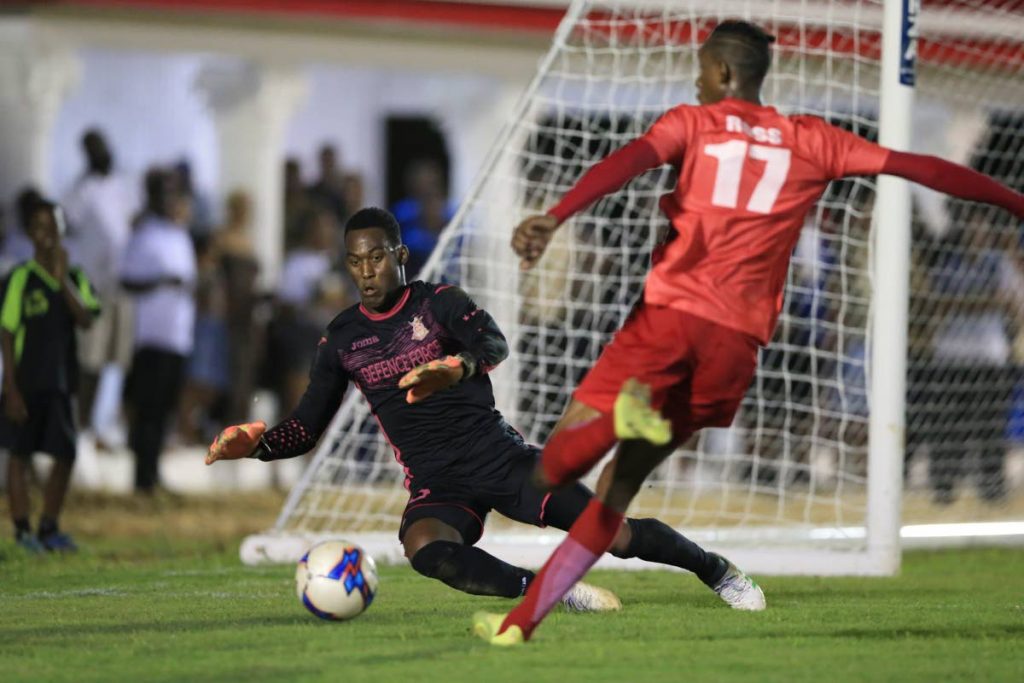 Defence Force’s goalkeeper Aaron Enill makes a save  from La Horquetta’s Ross Russell Jr. during the Ascension Invitational Tournament match, at Phase 2 La Horquetta Grounds, La Horquetta, on Saturday.