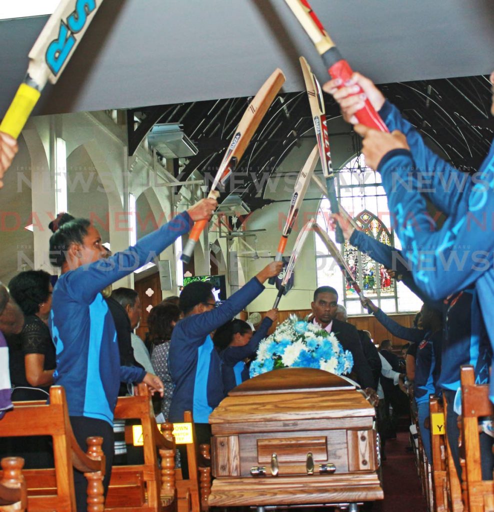 Cricketers from the K Rampath Cricket Academy, create a pathway for the late Burton Justin Dookhi during his funeral on Tuesday afternoon at Susamachar Presbyterian Church in San Fernando. PHOTO BY CHEQUANA WHEELER