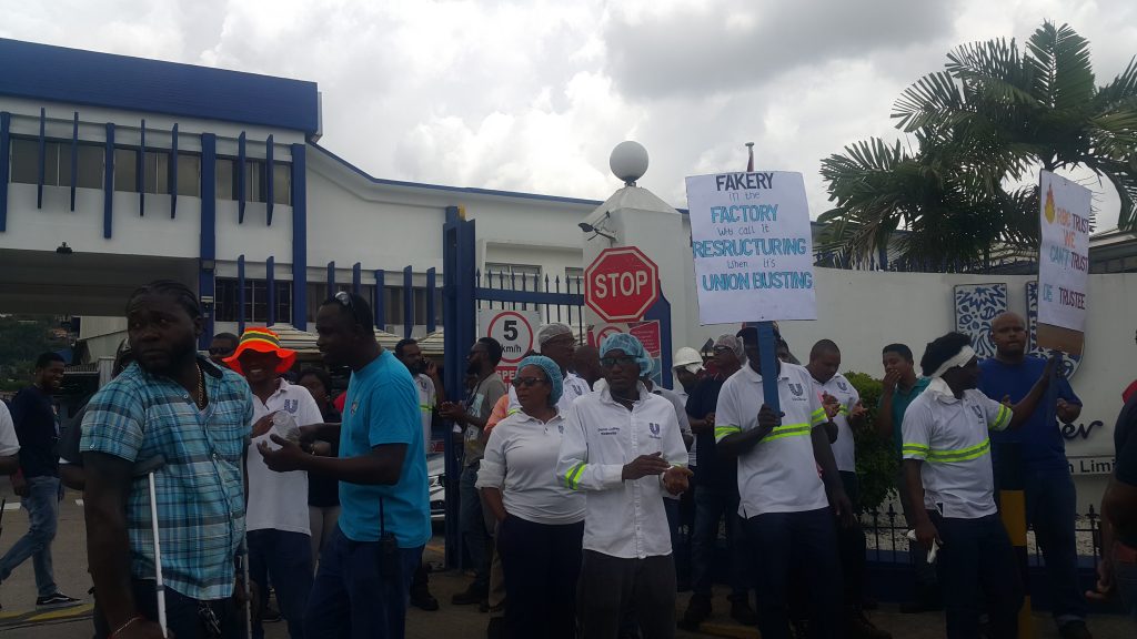 Unilever Caribbean Ltd workers protest outside the company's compound in Champs Fleurs. PHOTO BY NARISSA FRASER