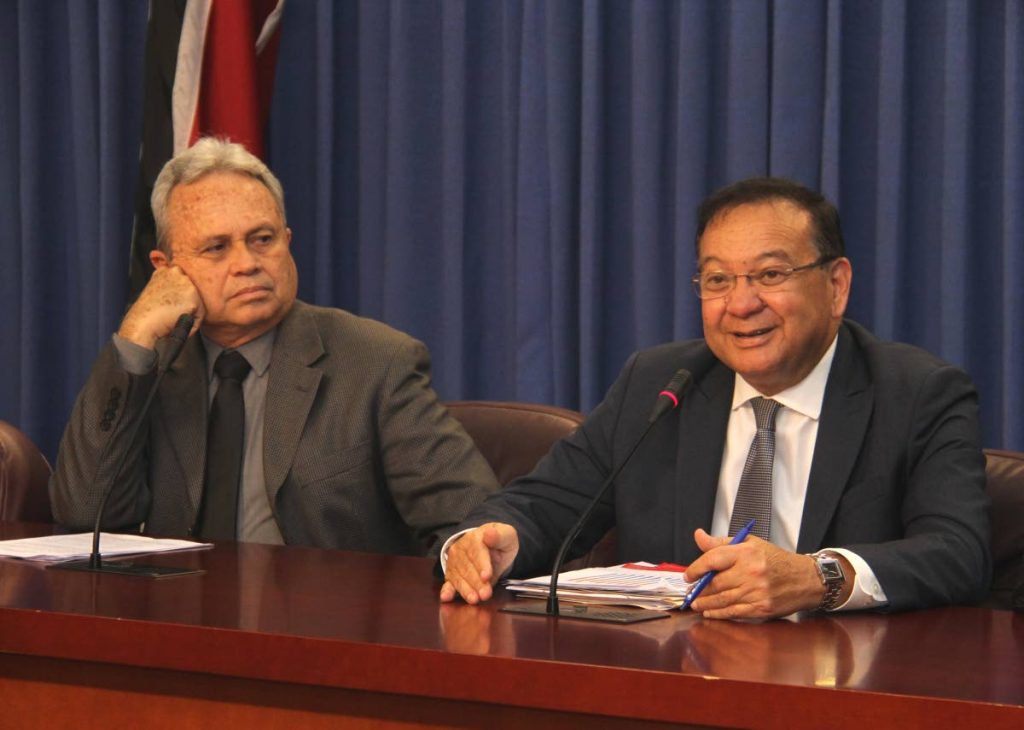 ENERGY TALK: Minister of Energy and Energy Industries Franklin Khan addresses reporters at yesterday’s post-Cabinet media conference at the Diplomatic Centre in St Ann’s.  Looking on is Finance Mnister Colm Imbert. 