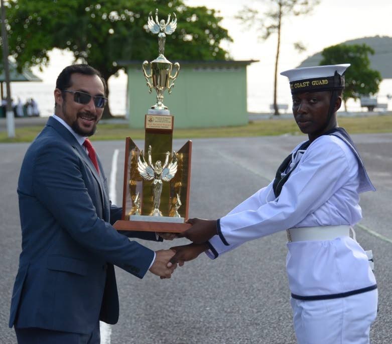 Minister of National Security Stuart Young presents Kadesha Theophilus with an award for best female recruit at a passing-out parade for the Coast Guard’s 55th recruit intake at Tetron Barracks Chaguaramas on Saturday 17 August, 2019. 
PHOTO COURTESY MINISTRY OF NATIONAL SECURITY