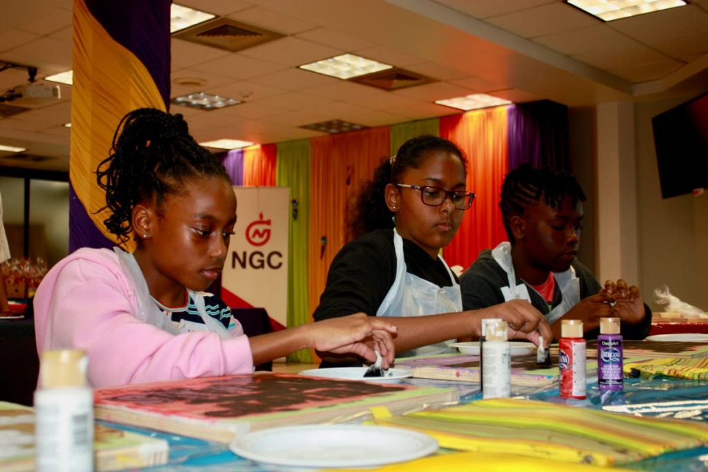 Students participating in a team-building painting activity.