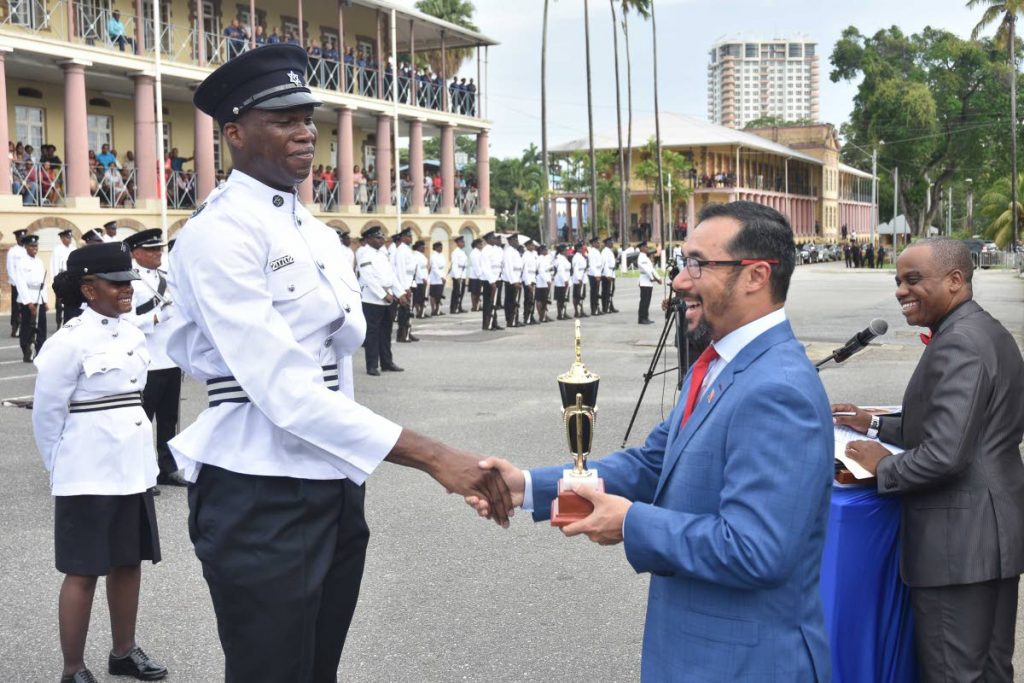 Minister of National Security Stuart Young present the award for Defensive Tactics to PC Humphey at the the Police Training Academy, St James on August 21.