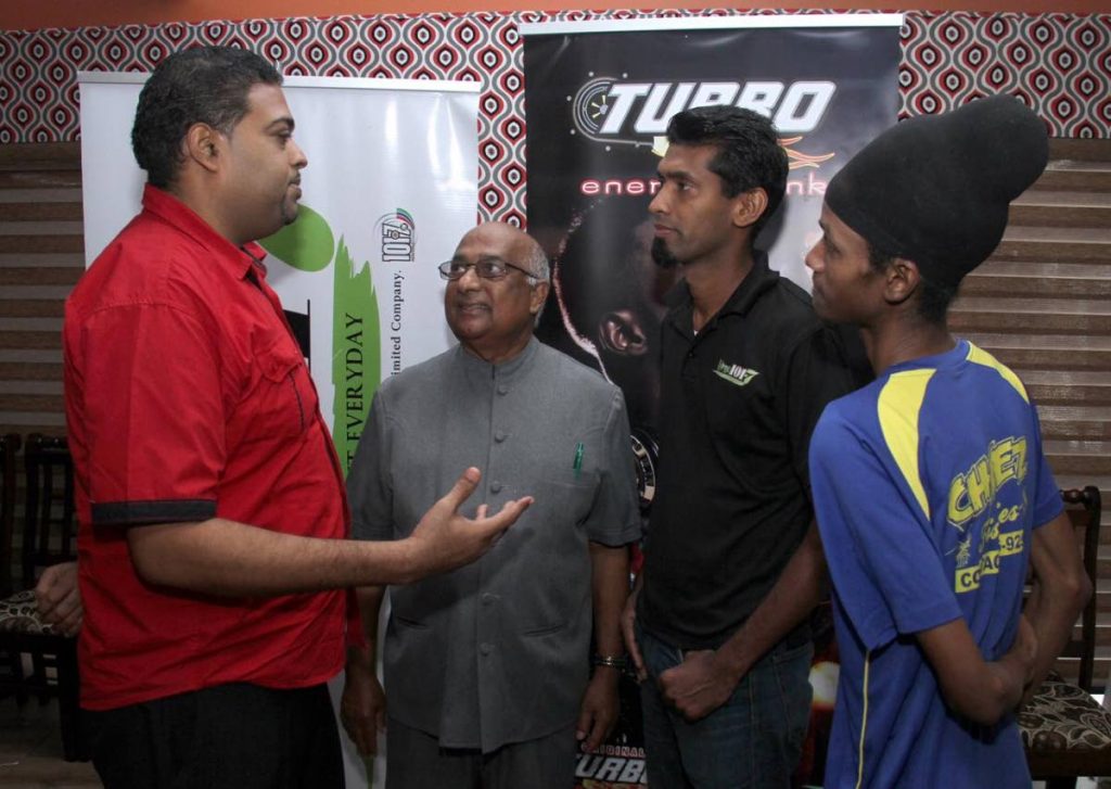 Lime 101.7 FM CEO Hans Hanoomansingh, second from left, chats with Ronnie Churawan, manager of Fearless, left, Lime 101.7 DJ Vijayanand Toophanie, second from right, and all fours official Ricardo Joseph, at the launch of the Lime 101.7 all fours tournament at Centre of Excellence, Macoya, last month. 
