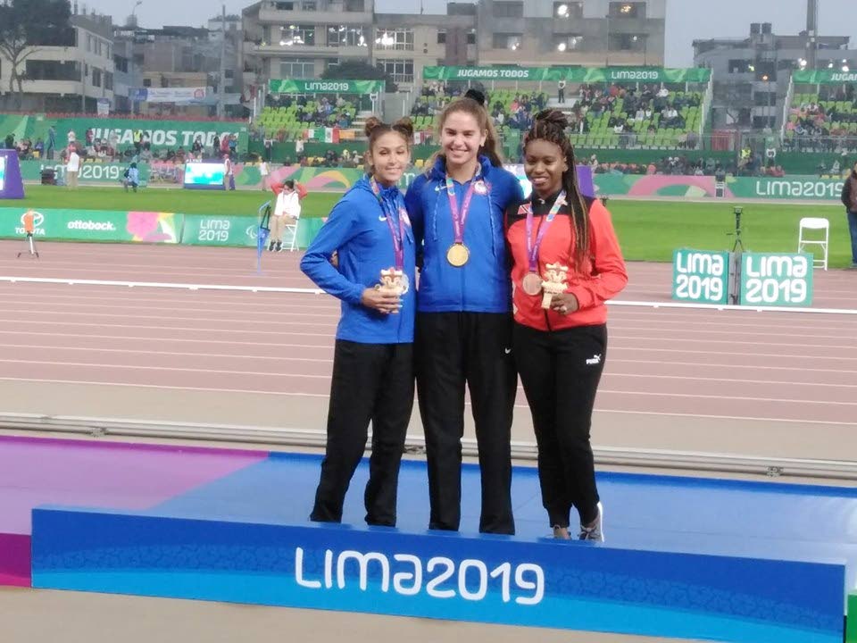 FIRST MEDAL: TT's Nyoshia Cain-Claxton, right, with her bronze medal on Sunday in the 200m Parapan Am final in Peru. Champ Beatriz Hatz, centre, and silver medallist  Sydney Barta are also on the podium. 