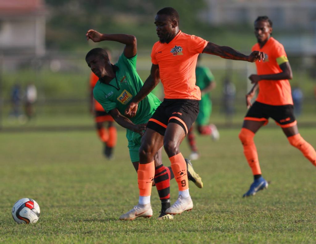 In this file photo, Club Sando FC’s Shackiel Henry, right, tries to gain control of the ball under pressure from  San Juan Jabloteh’s Jameel Neptune try to close him down during the Ascension Invitational match at the Mannie Ramjohn Stadium Training Ground, on Sunday.