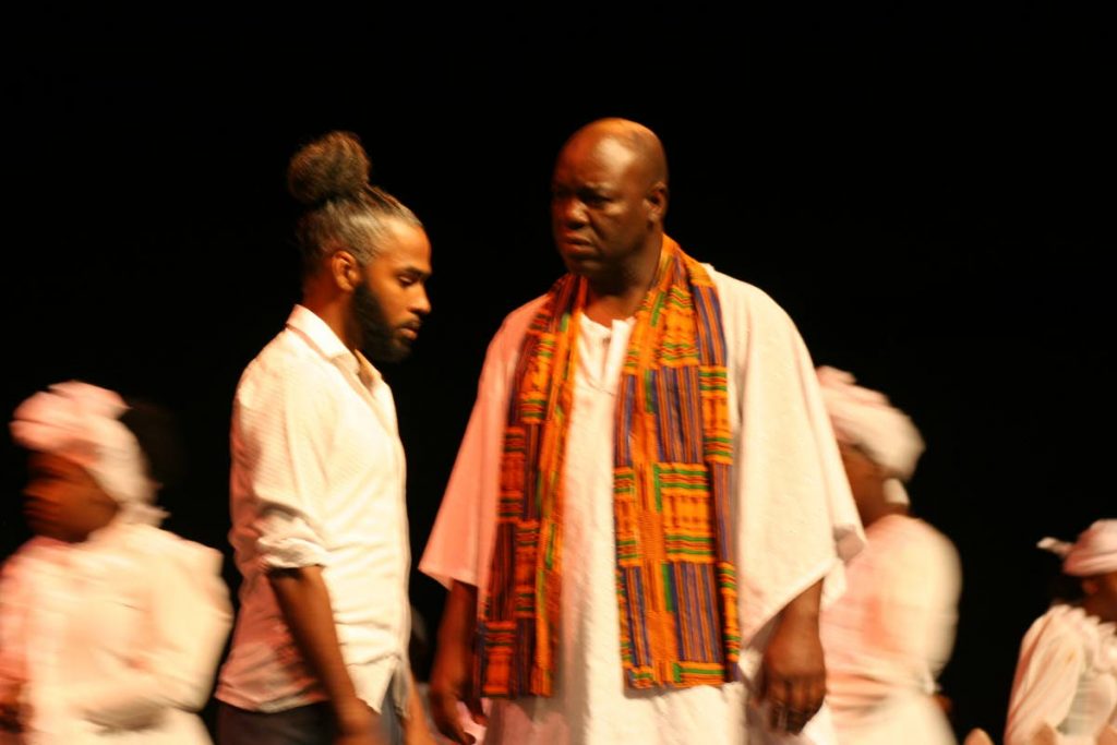 Sam played by Muhammad Muwakil talks to the village priest Papa Iban played by Kurtis Gross.