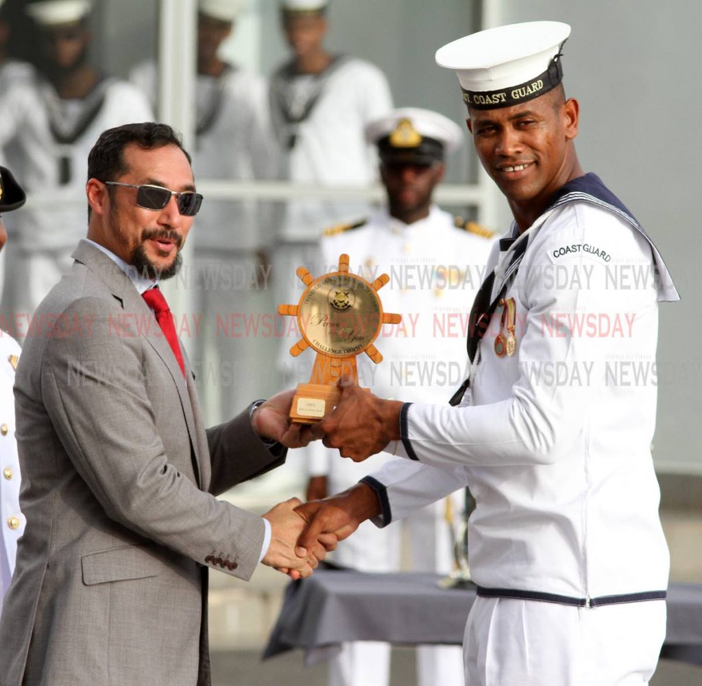 Able Seaman Medina V. receives the Rating of The Year Award, from Minister of National Security Stuart Young, at the Trinidad & Tobago Coast Guard's 57th anniversary parade, Staubles Bay Chaguaramas on Wednesday afternoon.

PHOTO:ANGELO M. MARCELLE