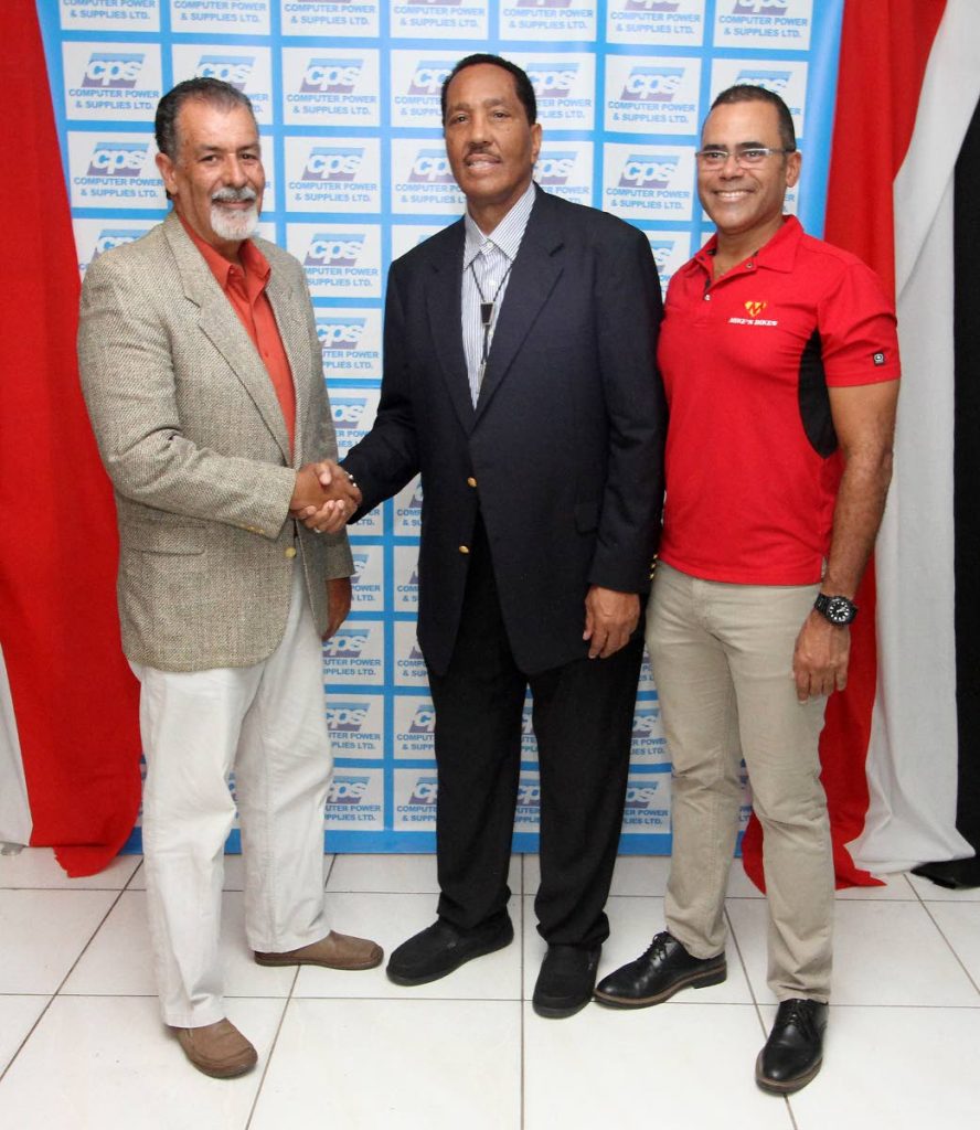 President of the TT Cycling Federation, Larry Romany, left, shakes hands with Computer Power and Supplies Solution Managing Director Patrick Phillips at the launch of the National Cycling Criterium Championship at Mike's Bikes, Woodbrook, yesterday. At right is cycling promoter Michael Phillips. PHOTO BY ANGELO MARCELLE