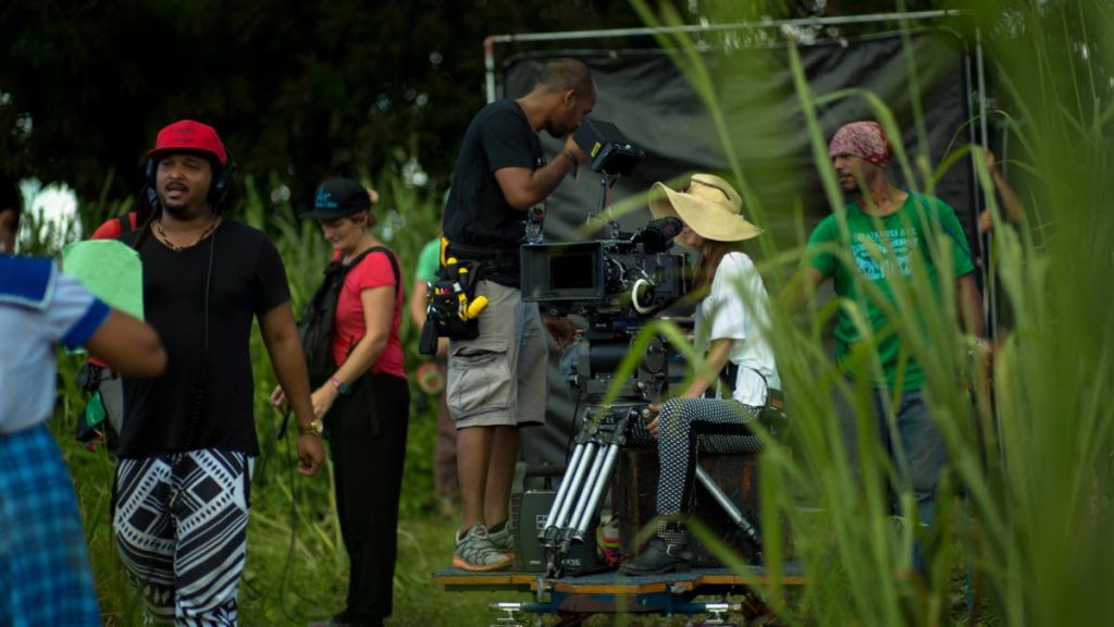 Making movies: Filmmaker Michael Mooleedhar, (left in red cap) on the set of Green Days by the River.