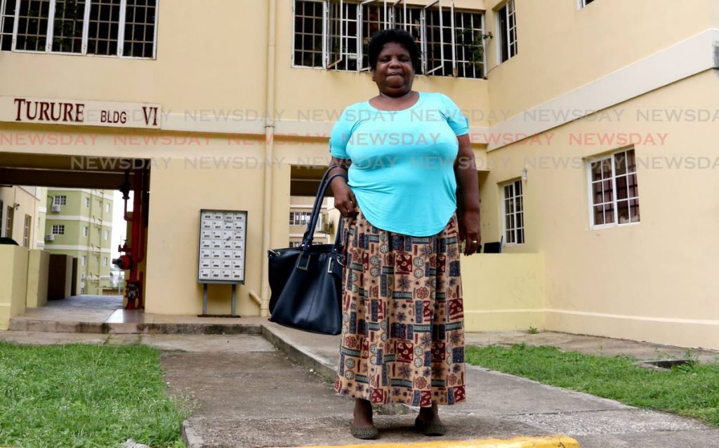 Zeia Flemming stands in front of her appartment building at Olera Heights, San Fernando. FILE PHOTO