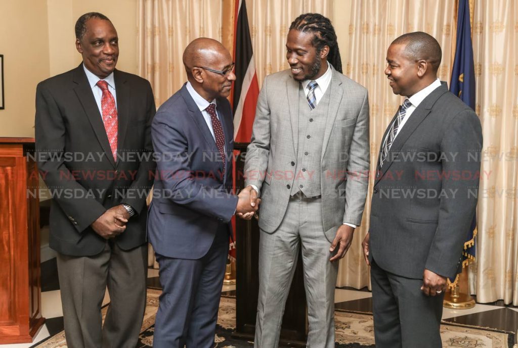 Minister of Public utilities Robert Le Hunte welcomes new parliamentary secretary in ministry of Public utilities Adrian Leonce also in photo MP Brigadier General Ancil Antoine (Ret.) at left and right senator Foster Cummings at Presidents House, St Anns on August 14.

Photo: JEFF K MAYERS