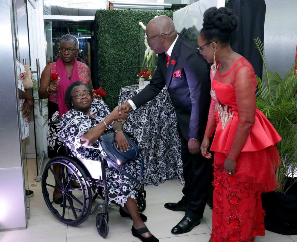 Chief Secretary Kelvin Charles, second from right, and his wife, Catherine Anthony-Charles, right, greet Kenetta Bobb, in wheelchair, and Visa Romeo-Guy at an Independence day reception in Scarborough on Thursday. 

 
