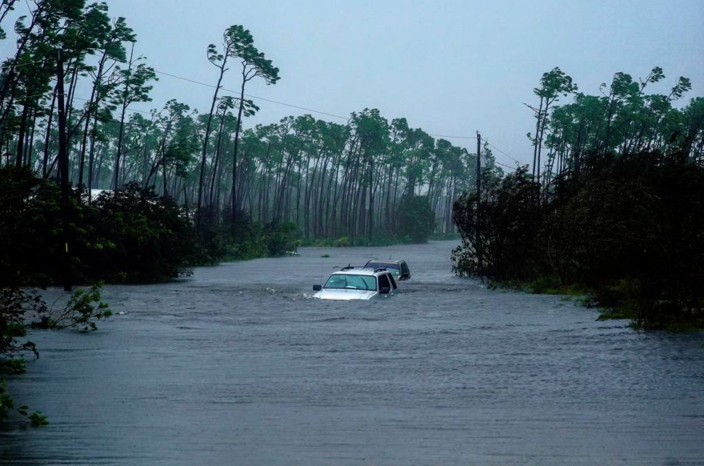 Cars sit submerged in water from Hurricane Dorian in Freeport, Bahamas, Tuesday, Sept. 3, 2019. Dorian is beginning to inch northwestward after being stationary over the Bahamas, where its relentless winds have caused catastrophic damage and flooding.(AP Photo/Ramon Espinosa)