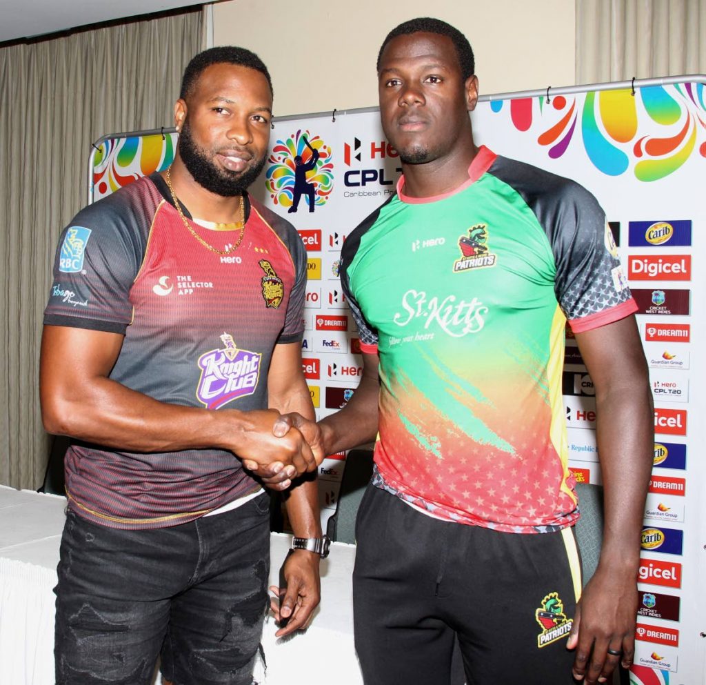 Trinbago Knight Riders captain Kieron Pollard,left, shakes hands with Carlos Brathwaite, captain of the St Kitts and Nevis Patriots, at a CPL media conference yesterday, at the Hilton Trinidad. Both captains will lead their teams in the opening match of the Hero CPL 2019 today at the Queen’s Park Oval,St Clair.